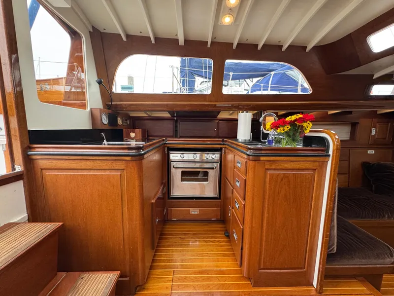 Slide: The Image of Interior of 1970 Sparkman and Stephens yacht with wooden cabinetry and modern kitchen appliances. - 6