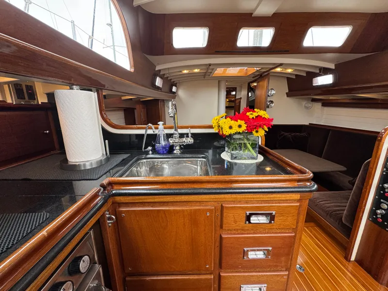 Slide: The Image of Luxurious 1970 Sparkman and Stephens yacht interior with wooden cabinetry and modern amenities. - 7