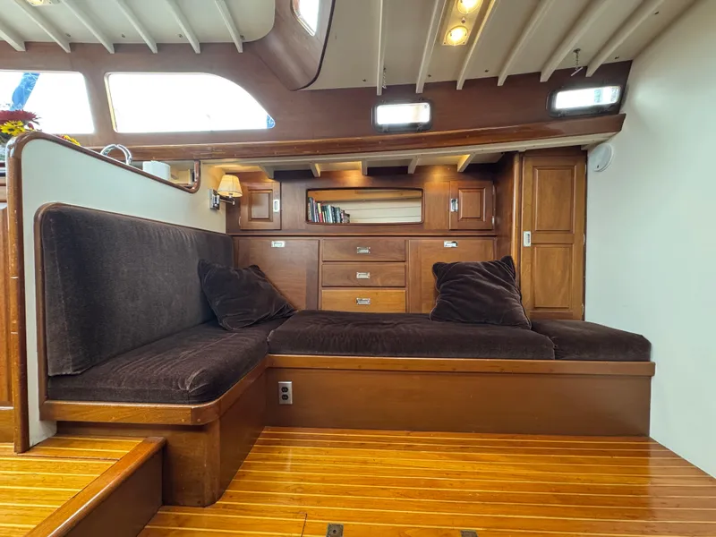 Slide: The Image of Luxurious 1970 Sparkman and Stephens yacht interior with wooden furnishings and plush seating. - 8