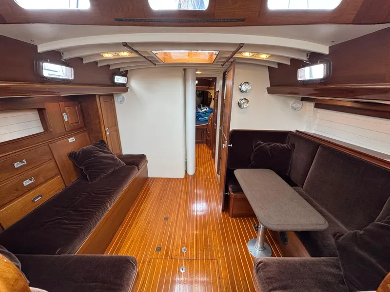Slide: The Image of Interior of 1970 Custom Sparkman and Stephens yacht with wooden flooring and plush seating. - 9