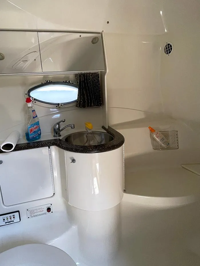 Slide: The Image of 2003 Formula 370 SS boat bathroom with sink, mirror, and cleaning supplies. - 11