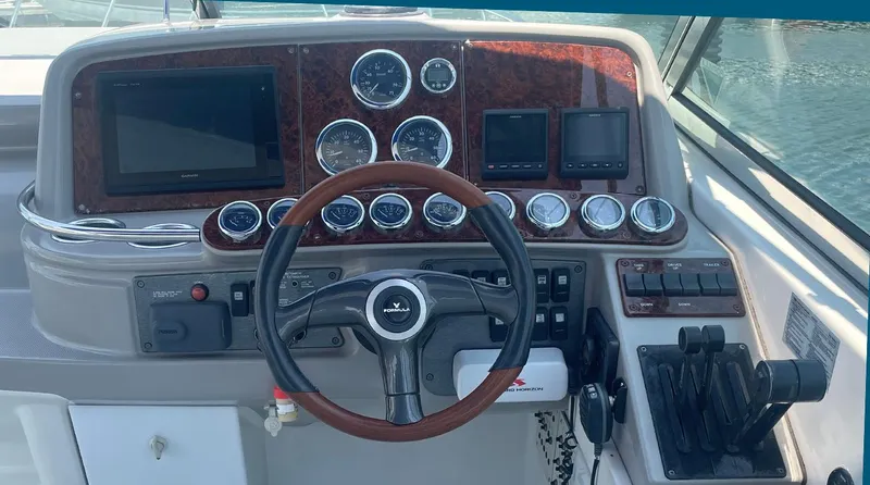 Slide: The Image of Dashboard of a 2003 Formula 370 SS boat with gauges and controls. - 5