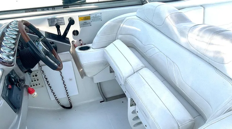 Slide: The Image of 2003 Formula 370 SS boat interior with white leather seating and steering wheel. - 6