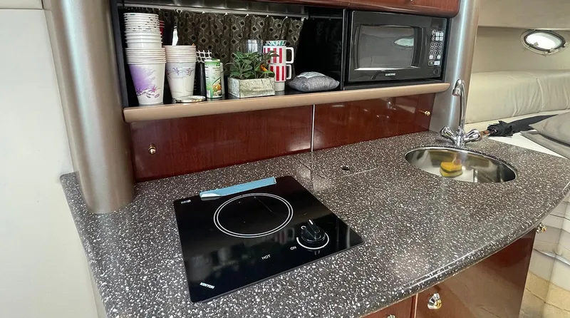 Slide: The Image of 2003 Formula 370 SS yacht kitchenette with stove, sink, and microwave. - 8