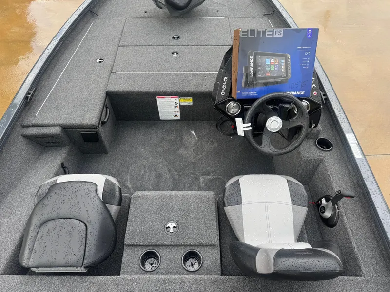 Slide: The Image of 2025 Crestliner XF 179 boat interior with wet deck and seating, parked on wet pavement. - 4