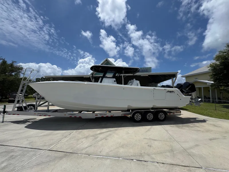 The Image of 2026 Invincible 36 Catamaran on trailer under a partly cloudy sky. - 1