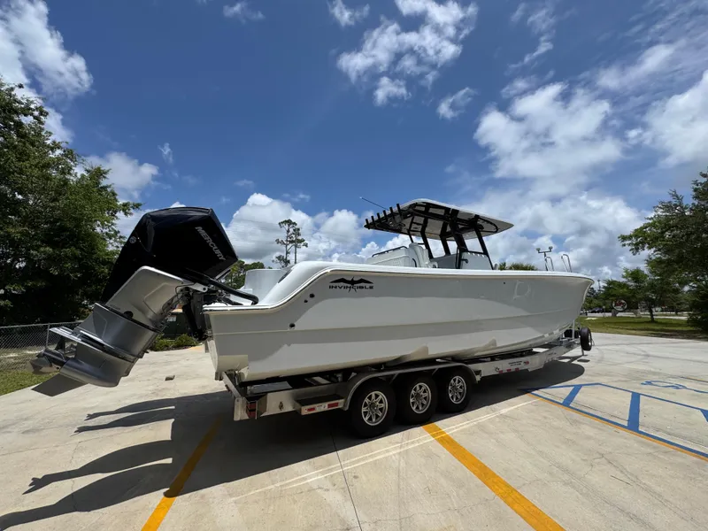 Slide: The Image of 2026 Invincible 36 Catamaran on trailer under blue sky with clouds. - 12