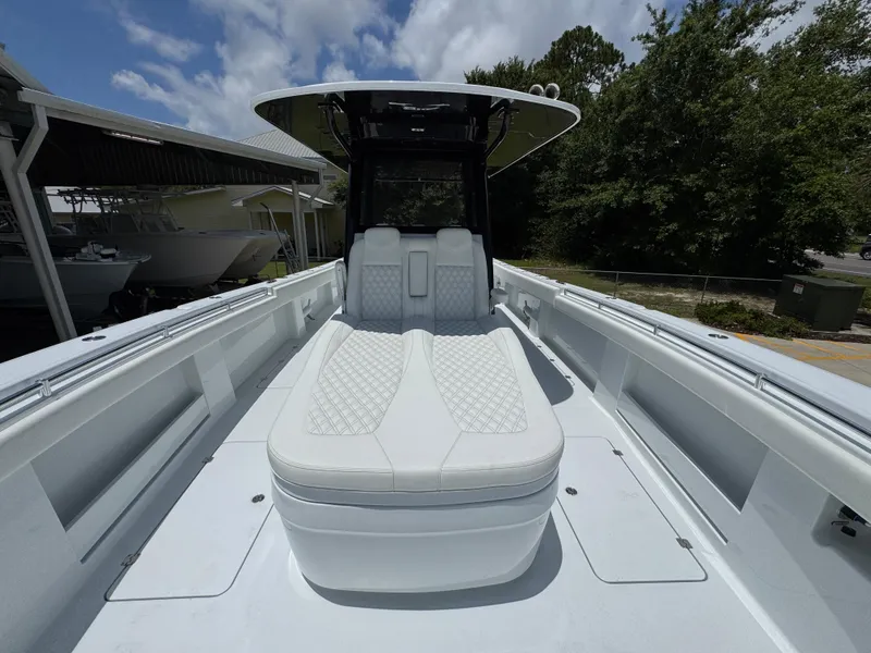 Slide: The Image of 2026 Invincible 36 Catamaran with sleek white seating and modern design under a blue sky. - 21