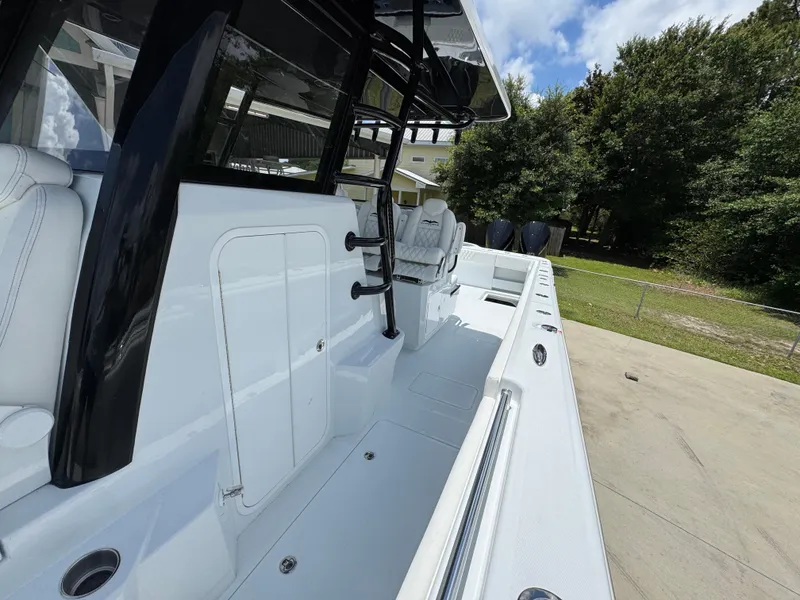 Slide: The Image of 2026 Invincible 36 Catamaran, sleek white deck, modern design, outdoor setting. - 26