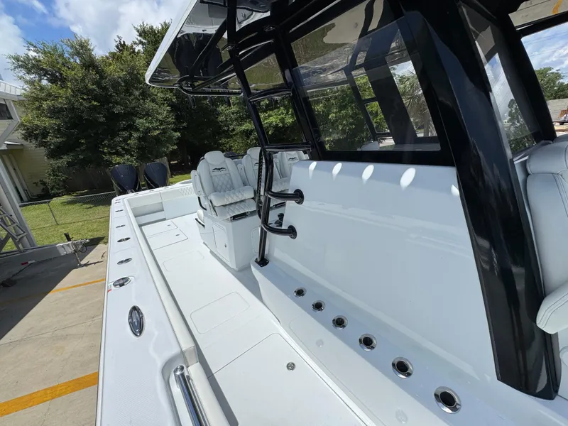 Slide: The Image of 2026 Invincible 36 Catamaran with sleek design and spacious deck in outdoor setting. - 27