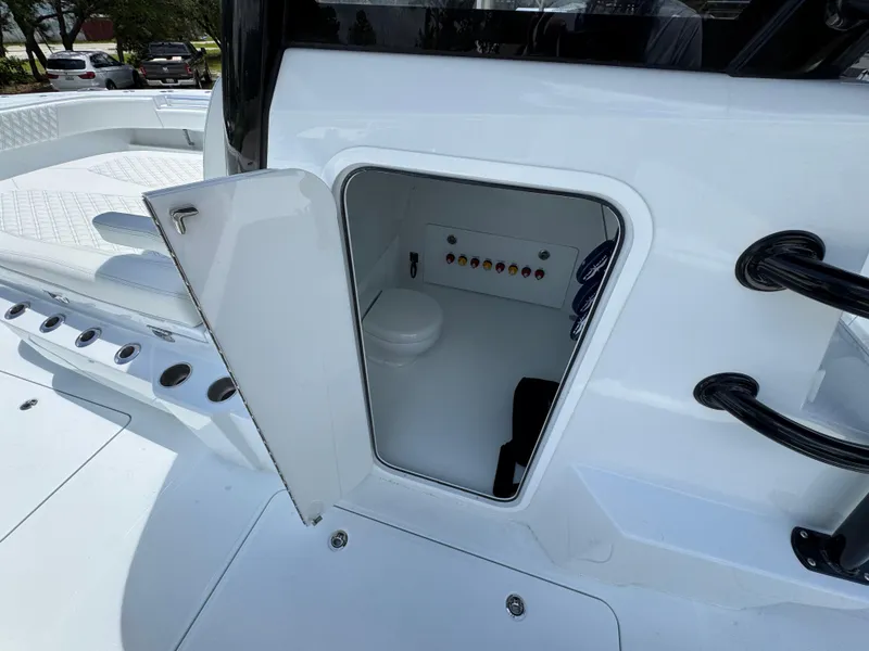 Slide: The Image of 2026 Invincible 36 Catamaran with open storage compartment and visible control panel. - 28