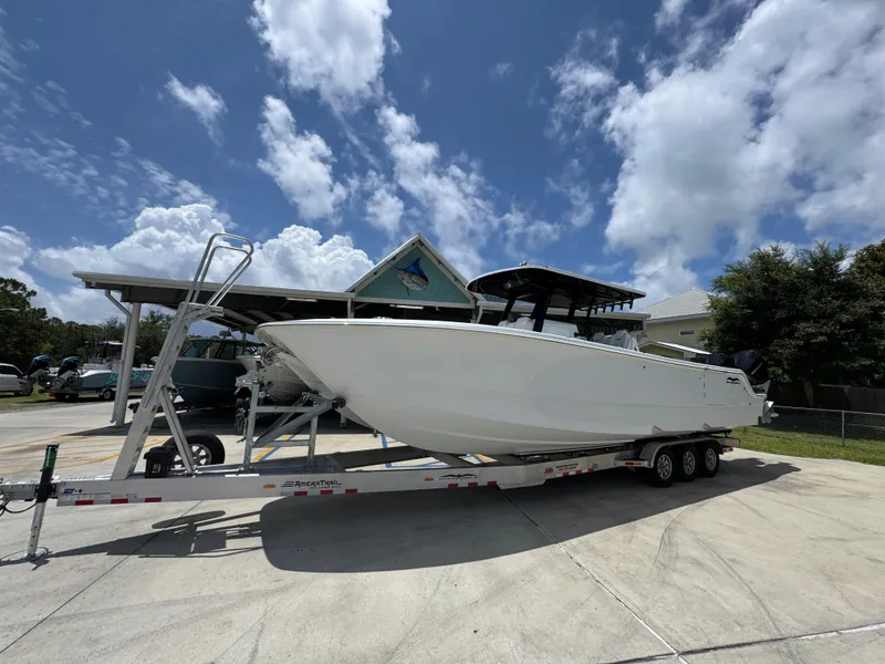 Slide: The Image of 2026 Invincible 36 Catamaran on trailer under blue sky with clouds. - 3