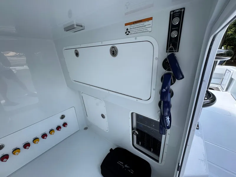 Slide: The Image of Interior view of 2026 Invincible 36 Catamaran, featuring control panel and storage compartments. - 30
