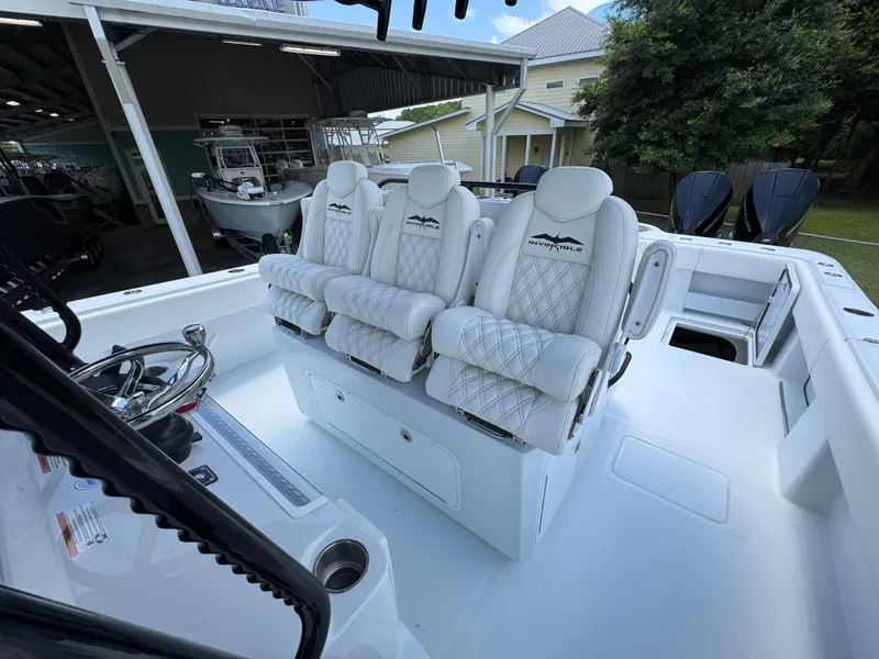 Slide: The Image of 2026 Invincible 36 Catamaran with luxurious white seating and modern helm controls. - 31