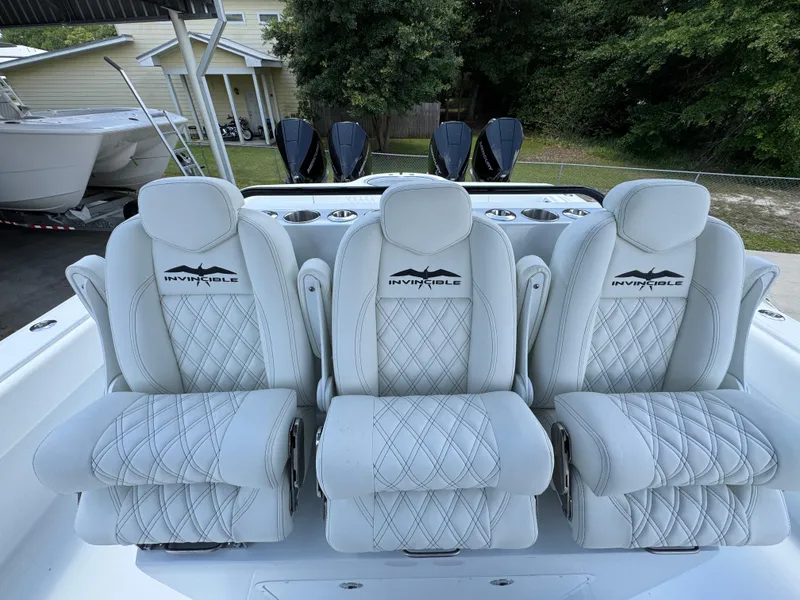 Slide: The Image of Luxury seating on 2026 Invincible 36 Catamaran with diamond-stitched upholstery and logo detailing. - 32