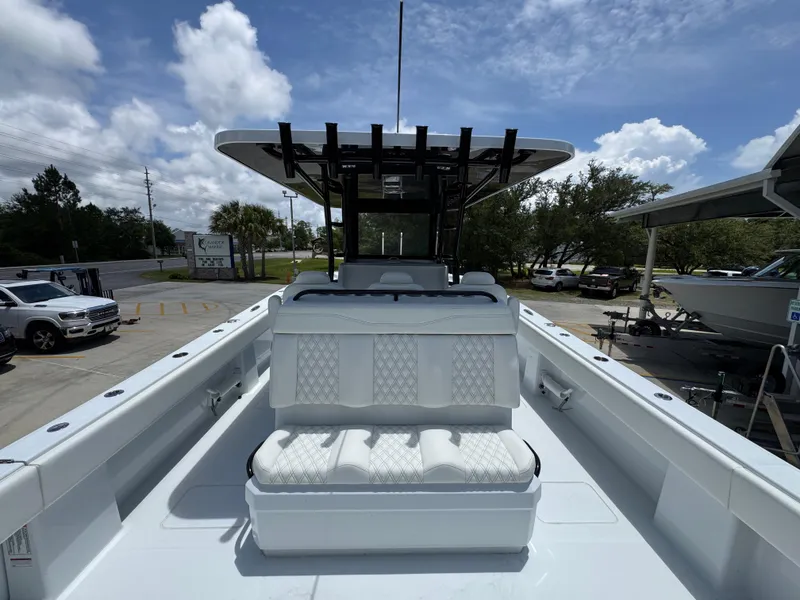 Slide: The Image of 2026 Invincible 36 Catamaran with sleek seating, docked under a partly cloudy sky. - 37