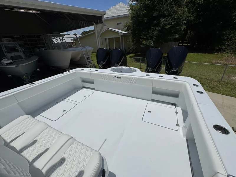 Slide: The Image of 2026 Invincible 36 Catamaran with spacious deck and seating, parked outdoors. - 40