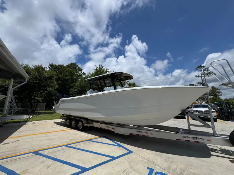 Slide: The Image of 2026 Invincible 36 Catamaran on trailer under blue sky, parked in a lot. - 9