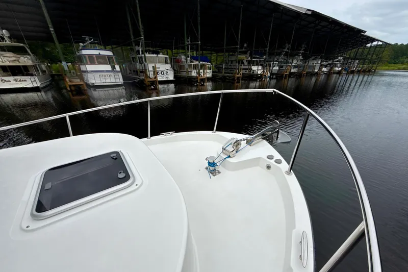 Slide: The Image of 2023 Nordic Tug 34 docked at marina, surrounded by other boats. - 11