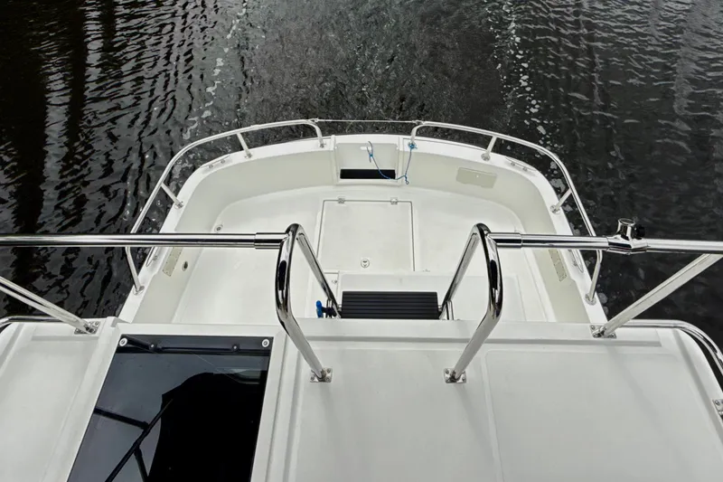 Slide: The Image of 2023 Nordic Tug 34 Tug boat deck with railing, overlooking water. - 6