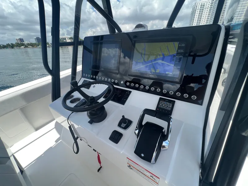 Slide: The Image of 2024 SeaVee 390Z boat dashboard with navigation screens and steering wheel. - 10