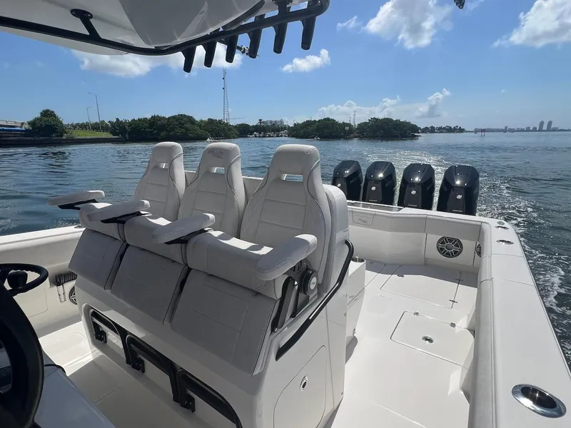 Slide: The Image of 2024 SeaVee 390Z boat with triple seats and multiple outboard engines on a sunny day. - 12