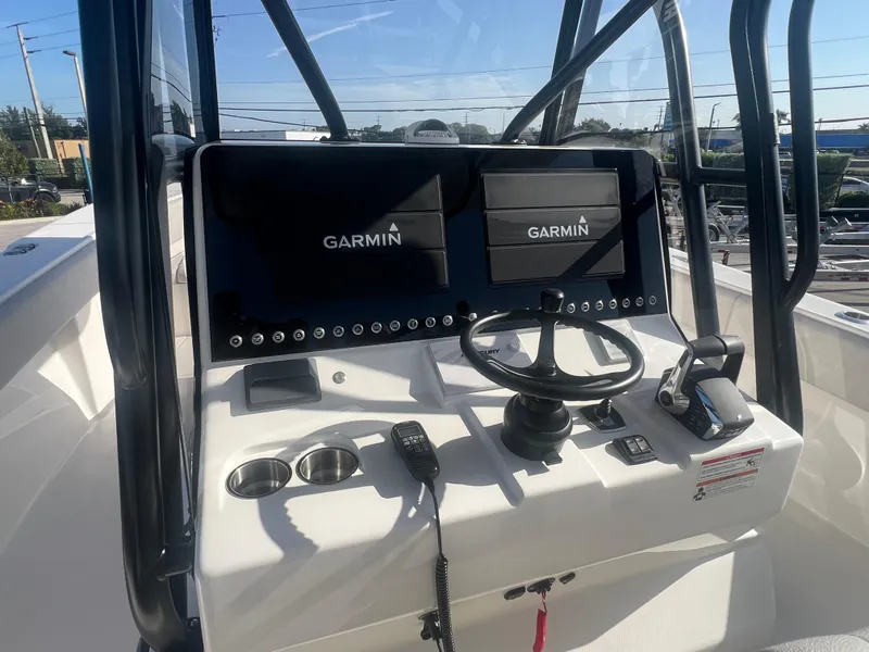 Slide: The Image of 2024 SeaVee 390Z boat console with dual Garmin displays and steering wheel. - 14