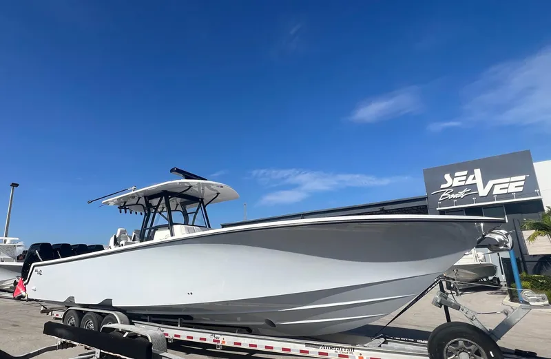 Slide: The Image of 2024 SeaVee 390Z boat on trailer under clear blue sky. - 6