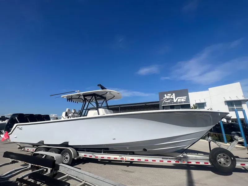 Slide: The Image of 2024 SeaVee 390Z boat on trailer under clear blue sky. - 7