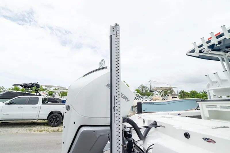 Slide: The Image of 2026 Crevalle 24 HCO boat with Mercury engine, parked near trucks and other boats. - 11