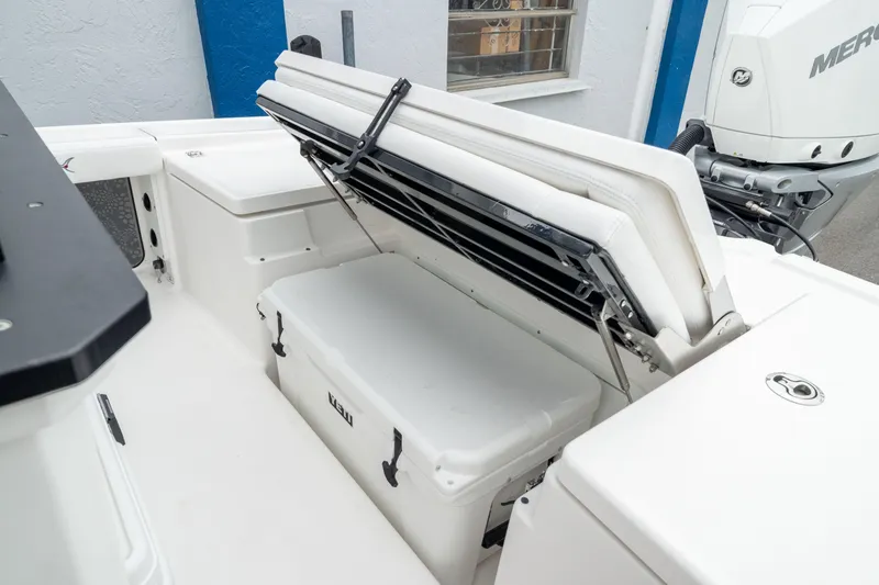 Slide: The Image of 2026 Crevalle 24 HCO boat with open storage compartment and cooler. - 17