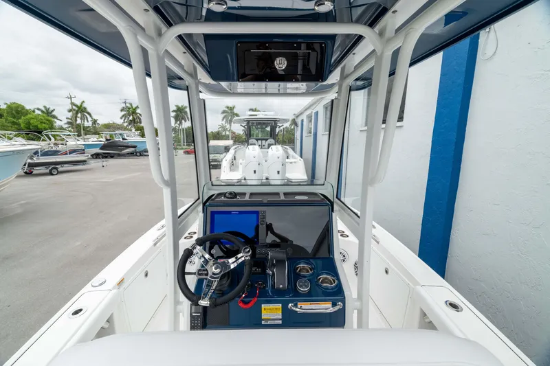Slide: The Image of 2026 Crevalle 24 HCO boat cockpit with steering wheel and control panel. - 21