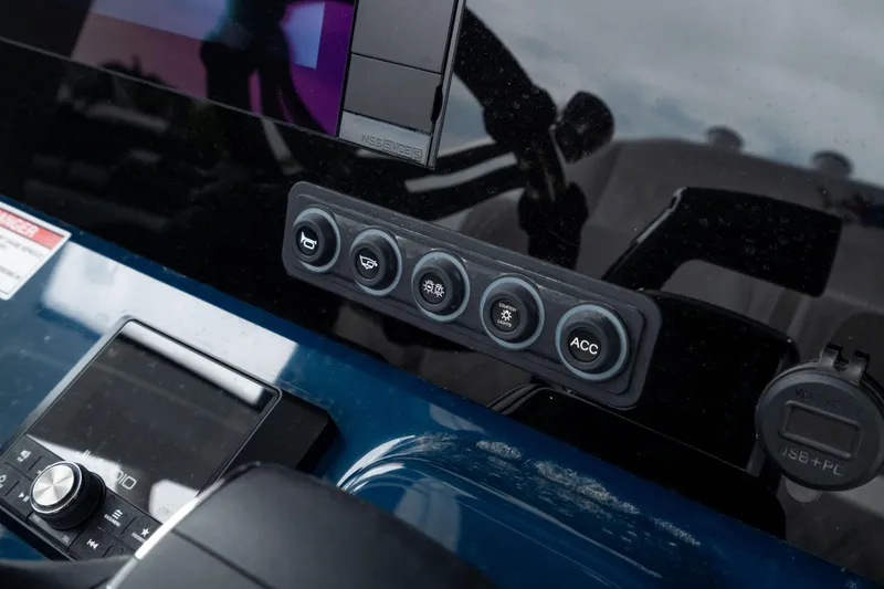 Slide: The Image of Control panel of 2026 Crevalle 24 HCO boat with various buttons and display. - 25