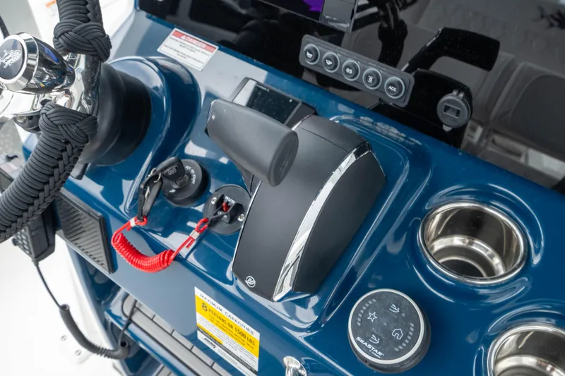 Slide: The Image of Control panel of 2026 Crevalle 24 HCO boat with throttle and cup holders. - 28