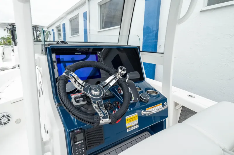 Slide: The Image of Helm of 2026 Crevalle 24 HCO boat with modern controls and steering wheel. - 3