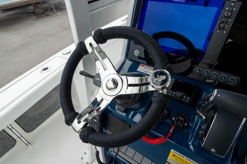 Slide: The Image of Steering wheel of 2026 Crevalle 24 HCO boat with modern dashboard controls. - 30