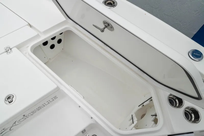 Slide: The Image of 2026 Crevalle 24 HCO boat storage compartment with open hatch, showcasing interior space. - 39