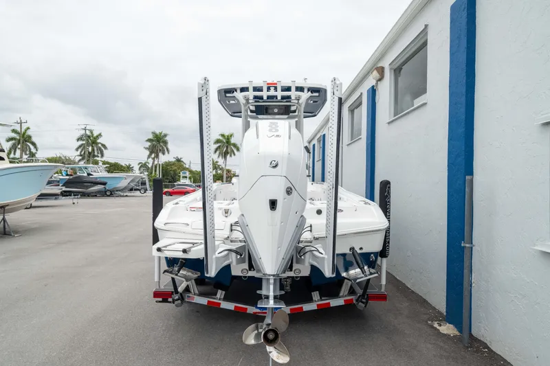 Slide: The Image of 2026 Crevalle 24 HCO boat on trailer, parked outdoors near a building. - 4