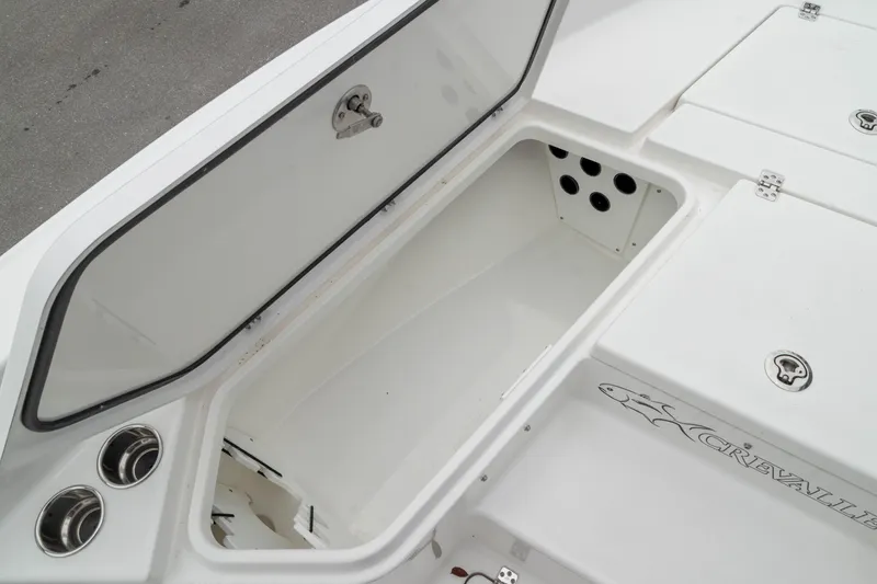 Slide: The Image of 2026 Crevalle 24 HCO boat storage compartment with open lid, showcasing spacious interior design. - 41