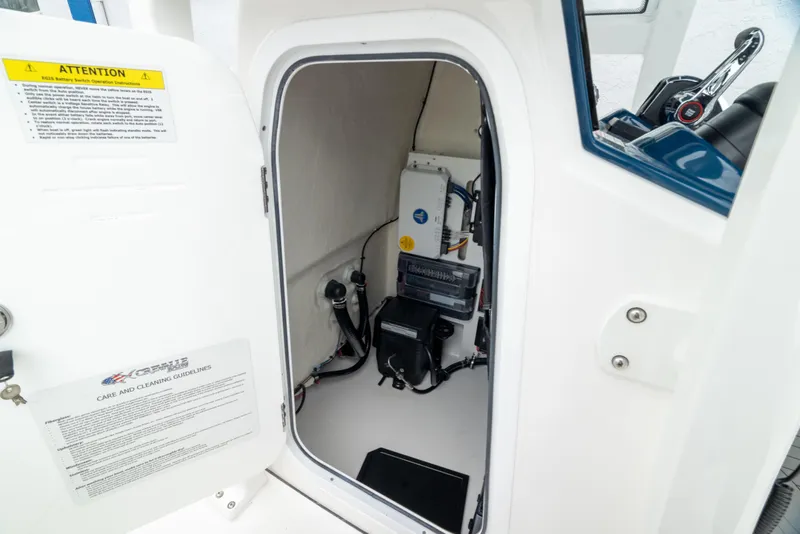 Slide: The Image of 2026 Crevalle 24 HCO boat interior compartment with equipment and wiring. - 44
