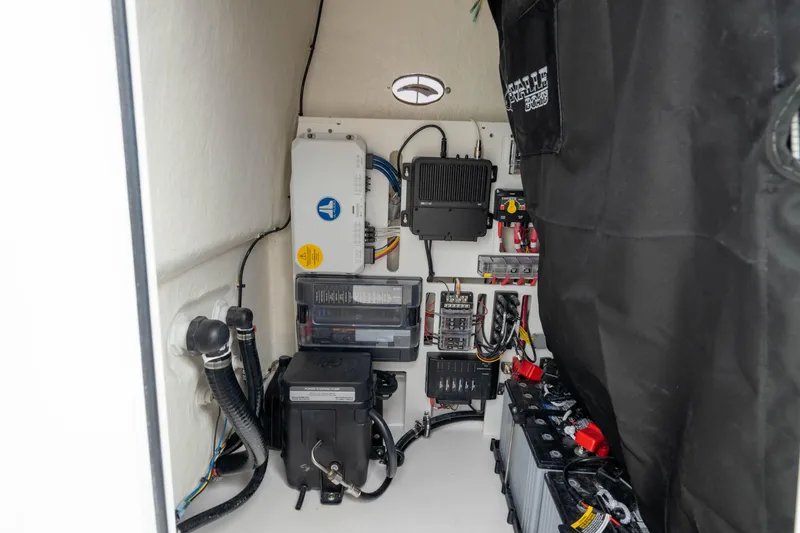 Slide: The Image of Electrical components inside a 2026 Crevalle 24 HCO boat, showcasing wiring and equipment. - 45