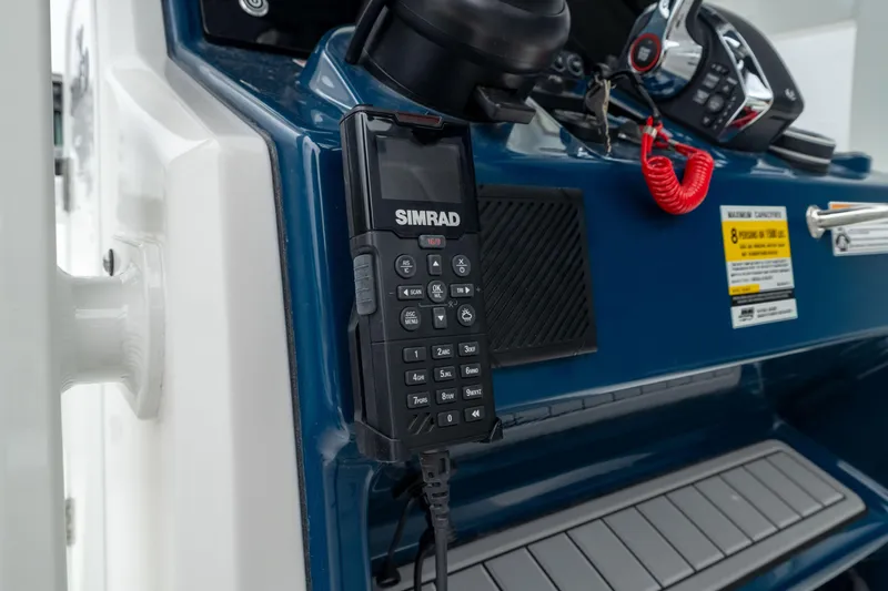 Slide: The Image of 2026 Crevalle 24 HCO boat dashboard with Simrad radio and control panel. - 46