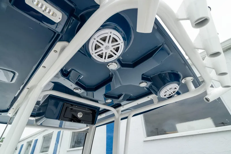 Slide: The Image of 2026 Crevalle 24 HCO boat with blue canopy and integrated speakers. - 47