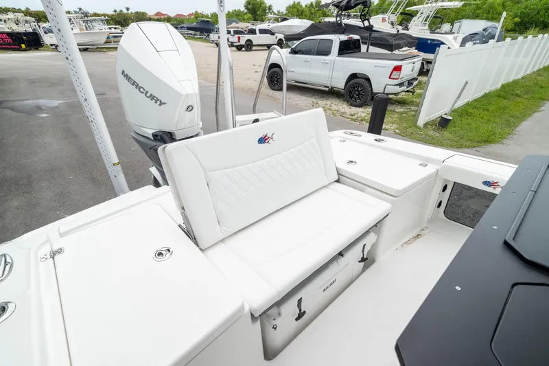 Slide: The Image of 2026 Crevalle 24 HCO boat with Mercury engine, white seating, and storage compartments. - 5