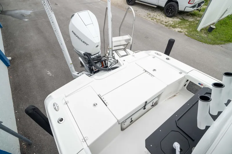 Slide: The Image of 2026 Crevalle 24 HCO boat with Mercury engine, viewed from above, parked on pavement. - 6