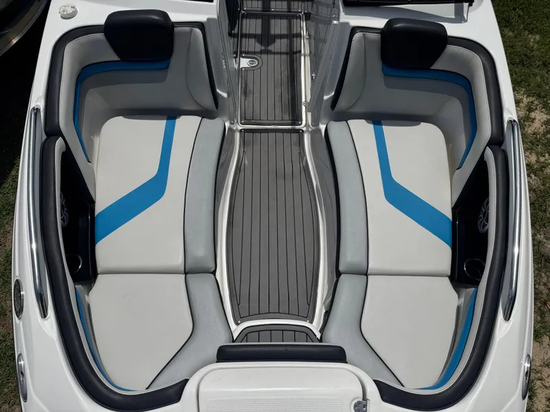 Slide: The Image of 2018 Yamaha Boats 242X E-Series interior with gray and blue seating, sleek design. - 18