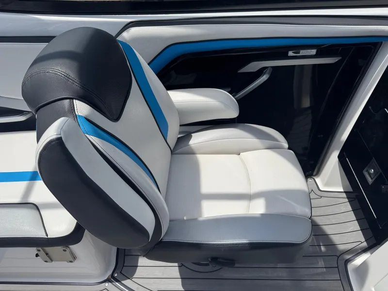 Slide: The Image of 2018 Yamaha Boats 242X E-Series interior seat with blue accents and sleek design. - 21