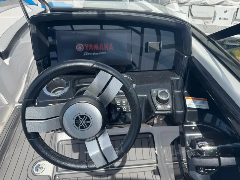 Slide: The Image of Steering console of 2018 Yamaha Boats 242X E-Series with digital display and controls. - 23