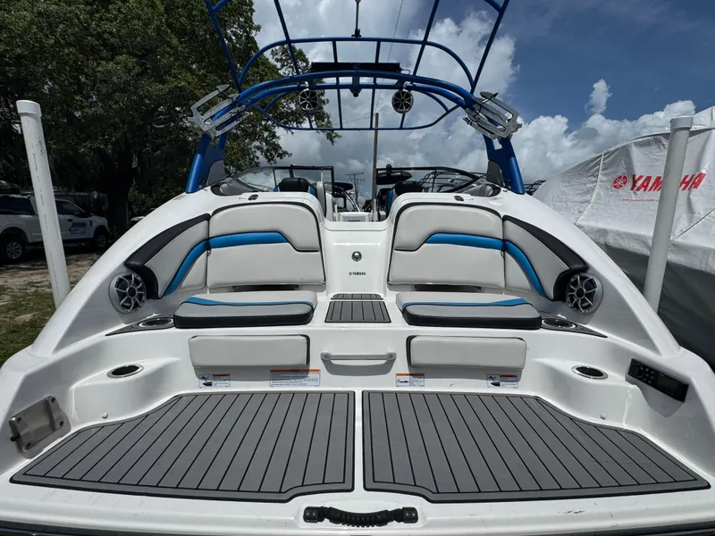 Slide: The Image of 2018 Yamaha Boats 242X E-Series, rear view, showcasing seating and deck design. - 4