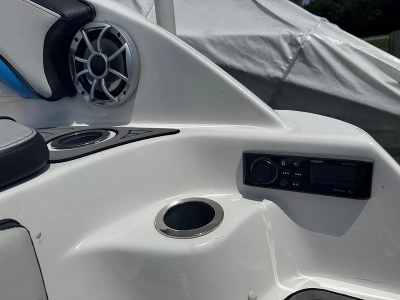 Slide: The Image of 2018 Yamaha Boats 242X E-Series interior with speaker, control panel, and cup holder. - 5